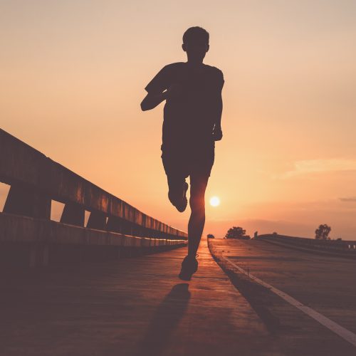 Athlete runner feet running on road, Jogging at outdoors. Man ru